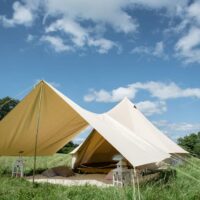 bell tent with awning in a field